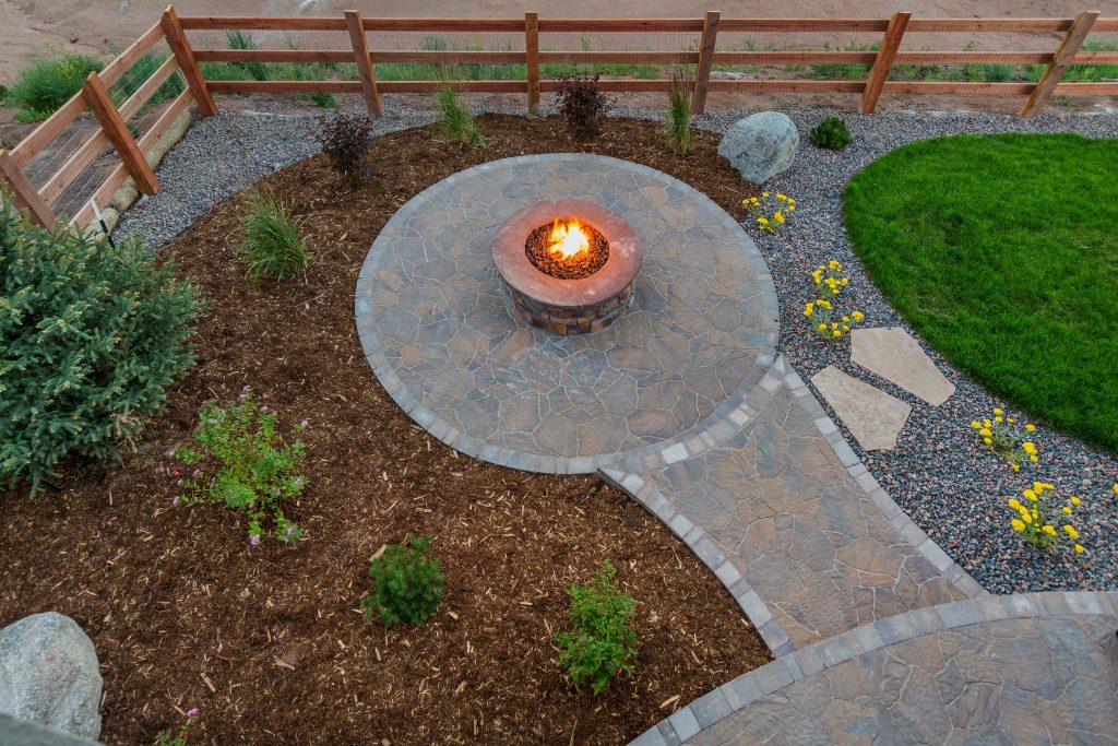 Circular fire pit surrounded by stone flooring